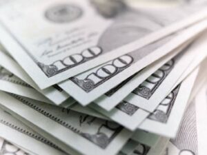 Stack of US dollar bills representing income used to explain how to calculate taxable income and personal finance planning