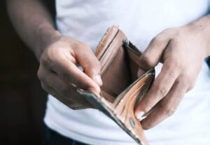 Person opening an empty wallet while searching for a personal loan with bad credit