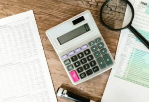 Person organizing bills and credit cards to consolidate debt with a personal loan