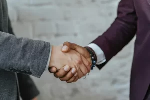 Joint loan agreement between two people shaking hands
