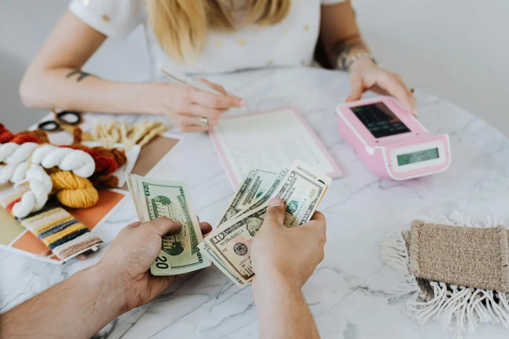 Cash being handed over during a no credit check loan transaction in Kearns, Utah