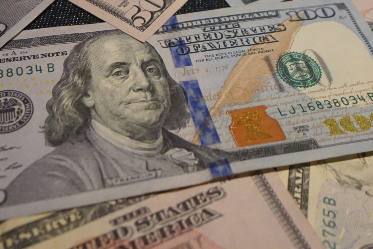 Close-up of hundred dollar bills symbolizing emergency personal loans in Utah County