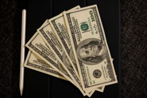 Stack of hundred-dollar bills representing no credit check loans in Midvale, Utah