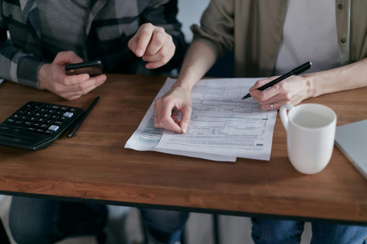 Person reviewing credit statement and calculator while analyzing credit utilization ratio in South Jordan, Utah